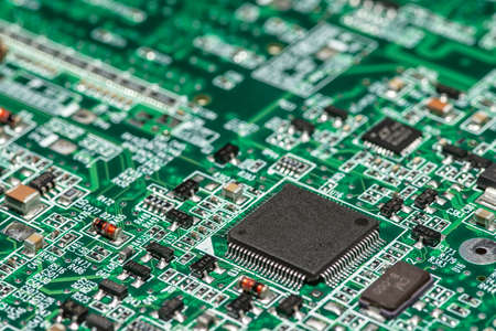 Macro image of a green computer printed circuit board with selective focus on an blank chipの写真素材
