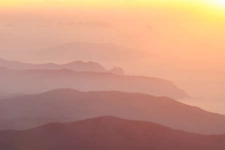 Misty chains of hills at dawnの写真素材
