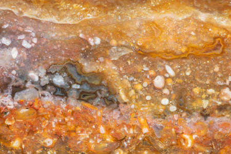 Texture of natural yellow-orange chalcedony with agate and fossilsの写真素材