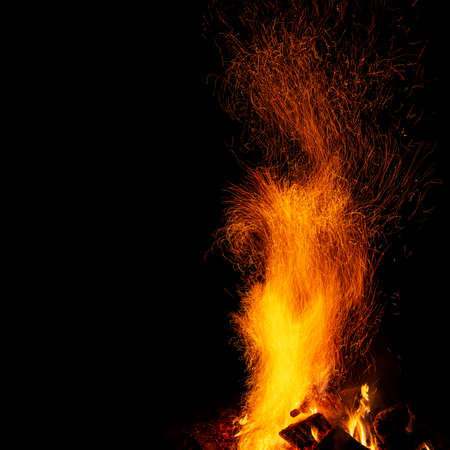 Campfire with sparks on a black background with a copy spaceの写真素材