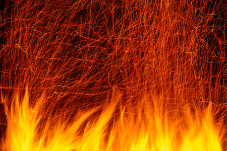 Flame with multiple traces of sparks on a long exposure with a black background horizontalの写真素材