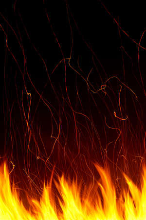 Flame with traces of sparks on a long exposure with a black background, verticalの写真素材