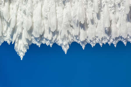 Close-up texture of a massive frost on a blue sky backgroundの写真素材