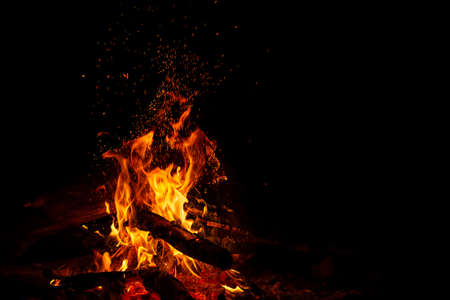 Bonfire with sparks on black with free spaceの写真素材