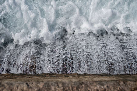 Abstract water flow with white foam top viewの写真素材