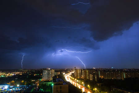Summer thunderstorm with multiple lightnings over Moscowの写真素材