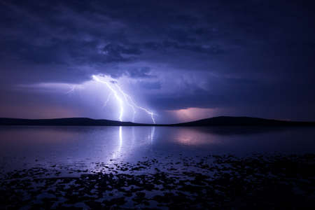 Massive triple lightning over the salt lake with reflection