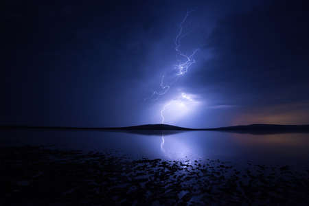 Night thunderstorm over salt lake with reflectionの写真素材