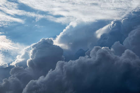 Dark cumulus clouds on a blue sky backgroundの写真素材