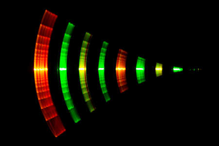 Abstract texture of red green yellow color light fluctuations on black backgroundの写真素材