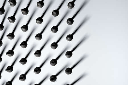 Abstract background of screws with shadows on white, top view, free spaceの写真素材
