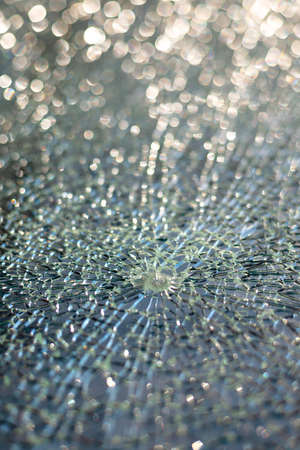 Broken glass texture, selective focus, shiny bokeh background