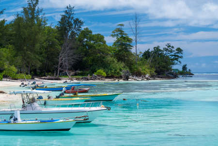 Motor boats in the turquoise waters near the coast of Seychelles islandの写真素材