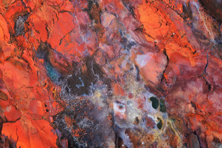 Full-screen close-up texture of multicolored mostly red Jasper with inclusions of pyrite and blue chalcedonyの写真素材