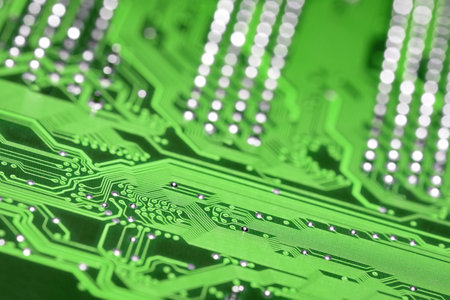 Green printed circuit board with selective focus and shiny pins bokeh background, diagonal compositionの写真素材