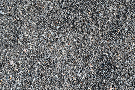 Close up full screen texture of fine gray limestone sea pebblesの写真素材