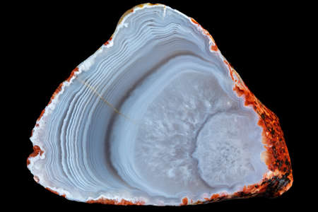 A sample of blue-white concentrically striped agate with quartz in the central part, isolated on a black background. Russia Kemerovo region.の写真素材