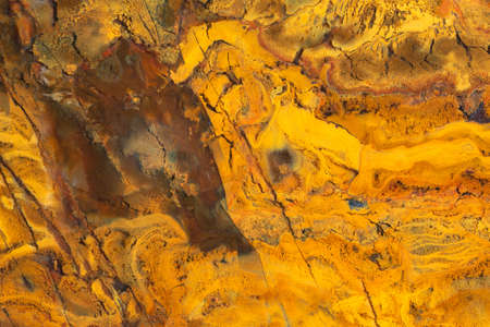 Full-screen close-up texture of yellow jasper stone.の写真素材