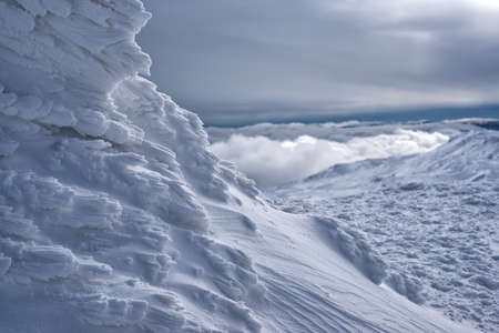 A rime-covered mountain ridge above the cloudsの写真素材