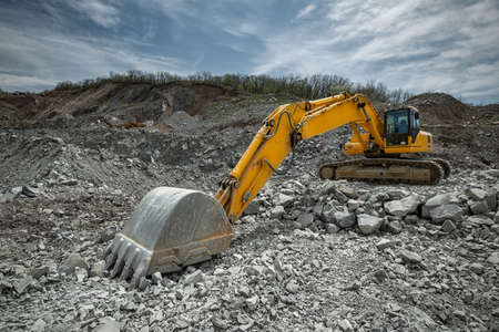 Yellow excavator in a stone quarry.の写真素材