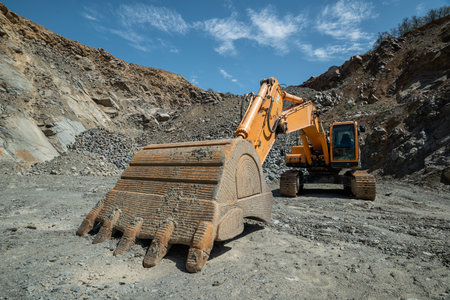 Orange excavator in an open-type stone quarry.の写真素材