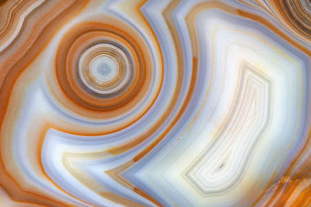 A full-screen texture of orange-white concentrically layered agate.の写真素材