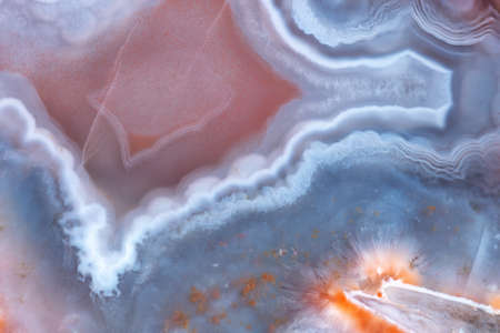 The texture of layered red-blue agate with the inclusion of bundles of orange zeolites.の写真素材