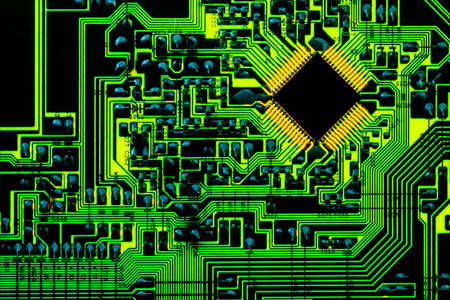 Backlit green printed circuit board with an blank microchip.の写真素材
