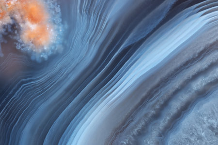 The texture of a beautiful blue striped agate with an orange inclusion.の写真素材