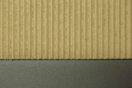 Corrugated cardboard photographed on dark stone background in horizontal lineの写真素材