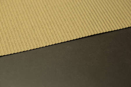 Corrugated cardboard photographed on dark stone background in diagonal lineの写真素材