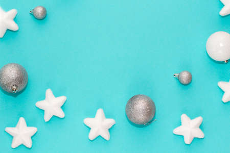 Frame of Christmas decorations on turquoise background, flatlay, overview, with free space for text.
