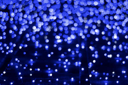 Abstract bokeh background with out of focus lights of classic blue color
