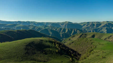 Drone shot of the valley of the mountains with lights and strong shadows.の写真素材
