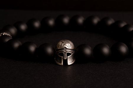 brutal male bracelet with black onyx stones and roman gladiator helmet elementの写真素材