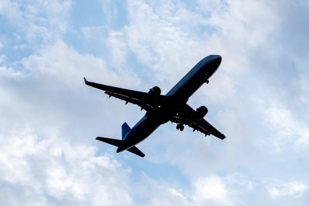Contrast silhouette of an airplane in the skyの写真素材