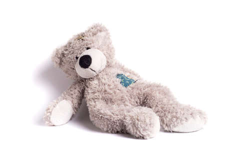 teddy bear with a patch on a white backgroundの写真素材