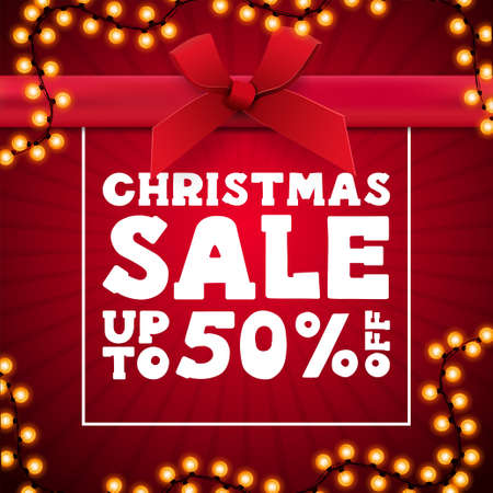 Christmas sale, red square discount banner in form of present box with frame of garland, large white offer and large red bow with ribbonのイラスト素材