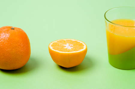 Production stages of an orange juice with orange and glassの写真素材