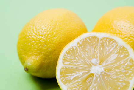 Arrangement of lemons against a green backgroundの写真素材