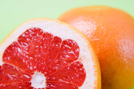 Arrangement of grapefruits against a green backgroundの写真素材