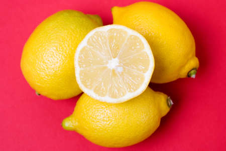 Arrangement of lemons against a red backgroundの写真素材