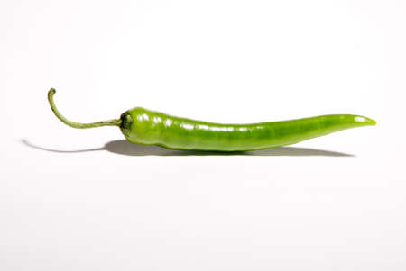 Green hot peppers with white background and shadowの写真素材