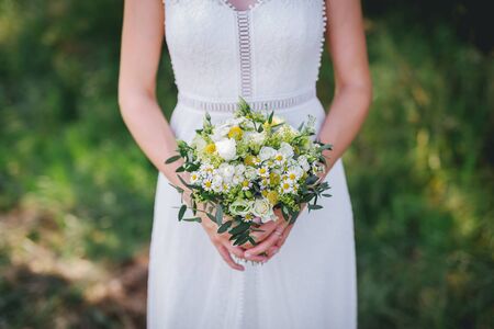 Bride holding flower bouquet close upの写真素材
