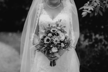 Bride holding flower bouquet close upの写真素材