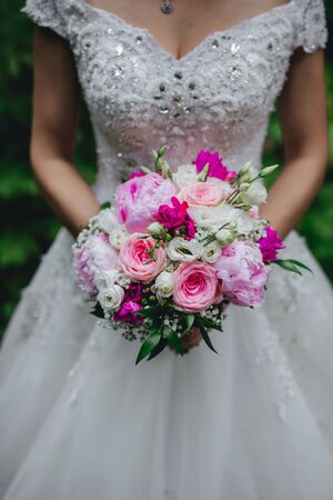 Bride holding flower bouquet close up