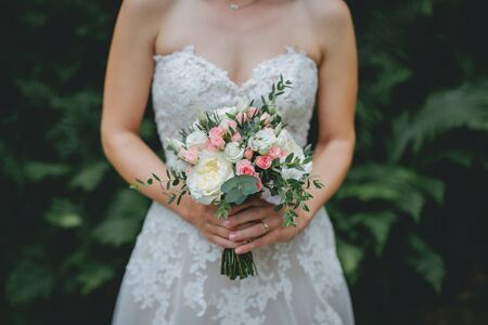 Bride holding flower bouquet close upの写真素材
