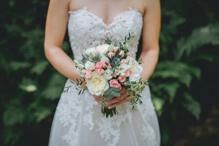 Bride holding flower bouquet close upの写真素材
