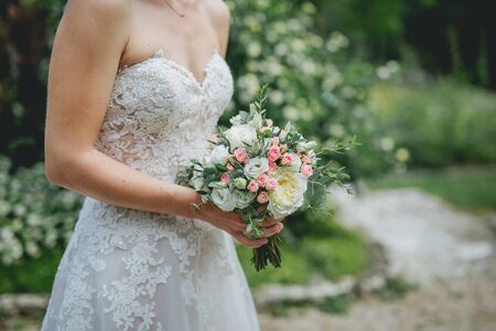 Bride holding flower bouquet close up