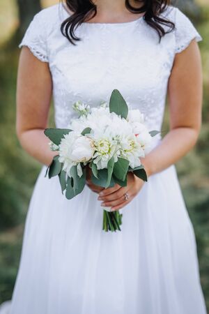 Bride holding flower bouquet close upの写真素材